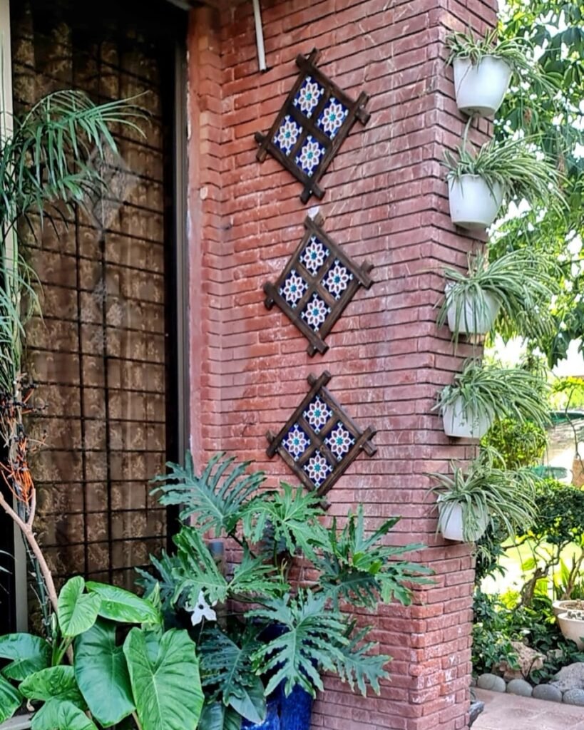 handcrafted wooden frames featuring colorful ceramic tiles with intricate geometric patterns, arranged on a dark wood surface. Each tile displays a unique starburst design in vibrant colors such as blue, teal, and terracotta, creating a visually striking and culturally inspired piece of wall decor.